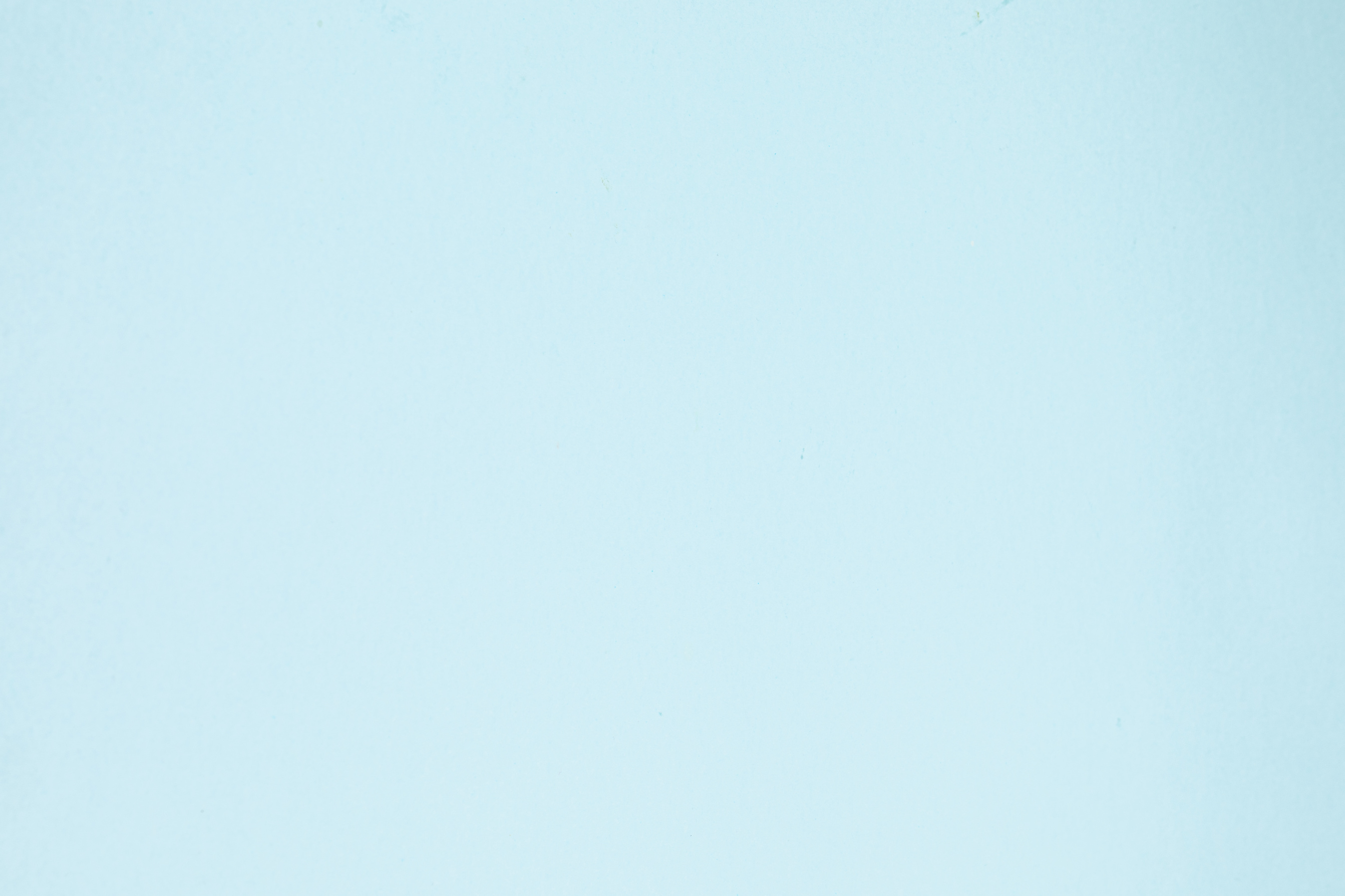 Light pastel blue paper textured background